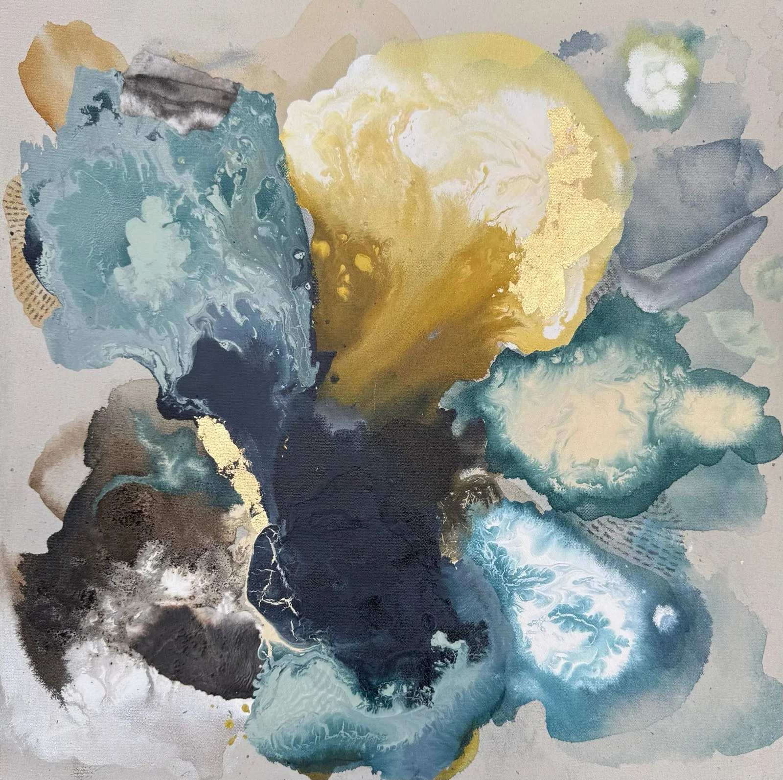 Fluid pools of teal, petrol blue and deep ink-navy bloom across a warm linen-grey ground, met by soft buttery yellow and ochre, with veins and flecks of gold leaf; watery, organic and atmospheric.